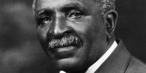 portrait photograph of george washington carver looking to his left, he wears a suit