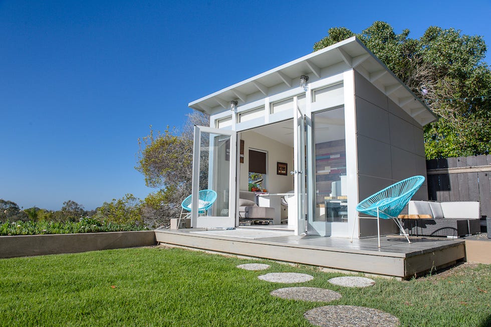 modern backyard structure with a deck and seating area