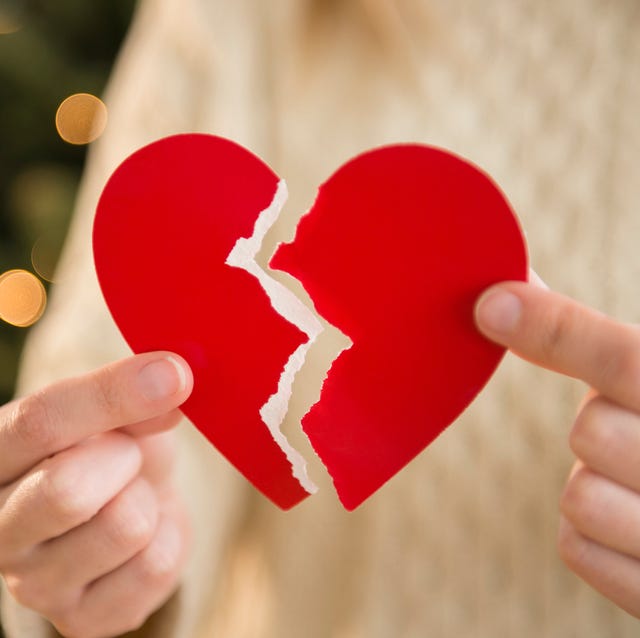 studio shot of female's hands holding broken heart