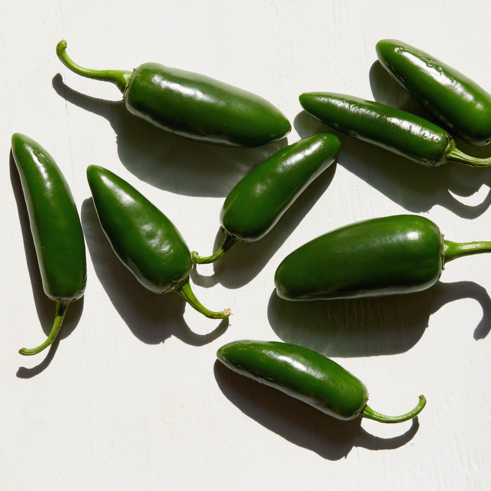 studio shot of green jalapeno peppers