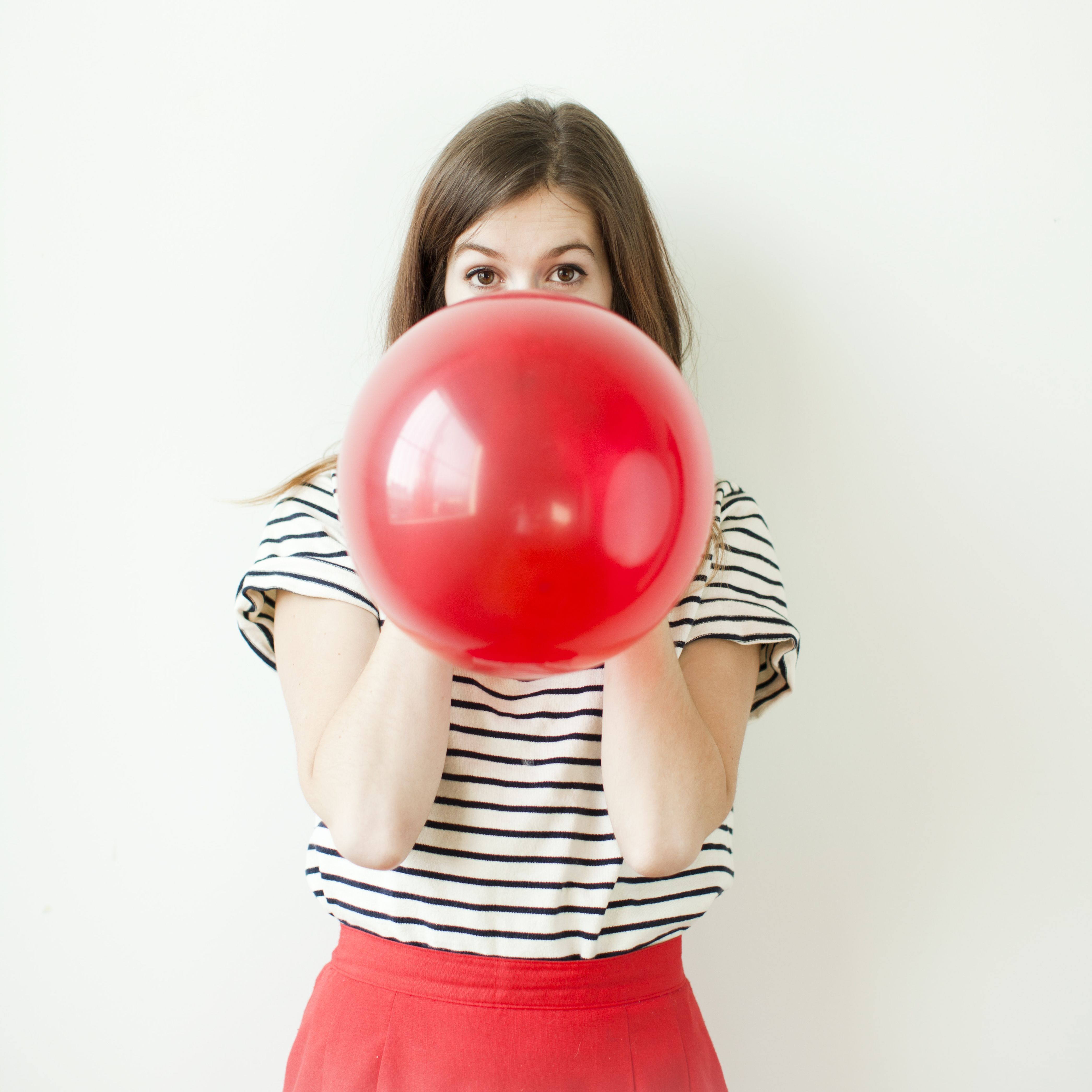 Girl Blowing Balloons