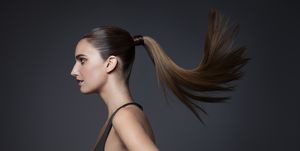 studio shot of young woman tossing hair