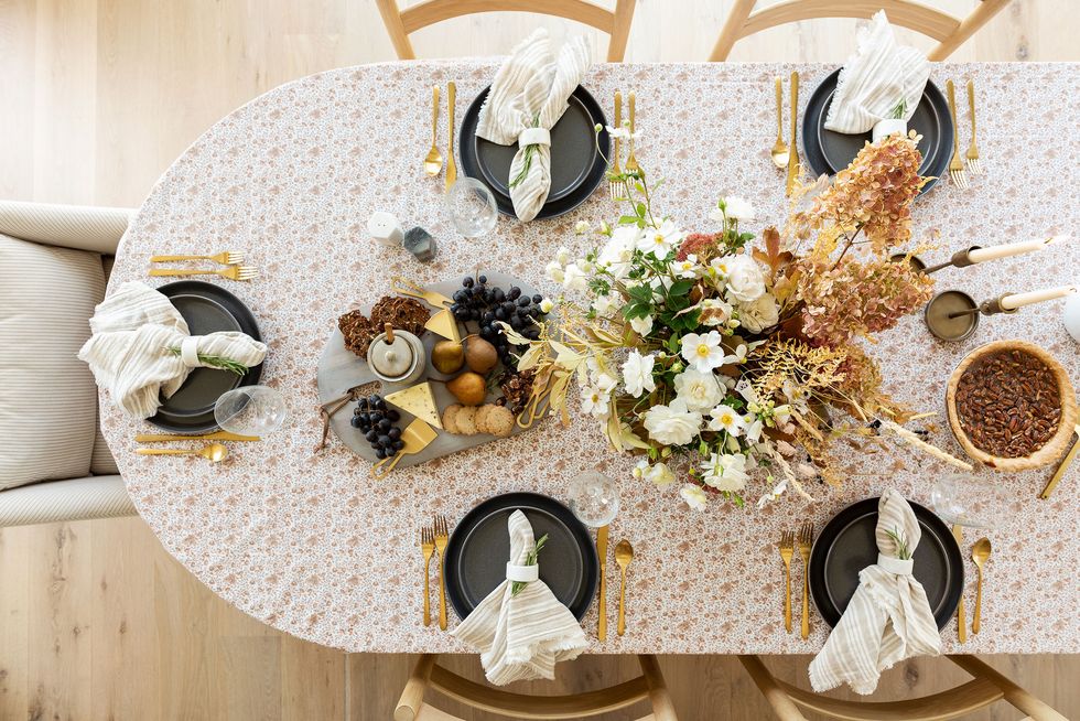 a top down perspective of a table set with gold flatware and black plates
