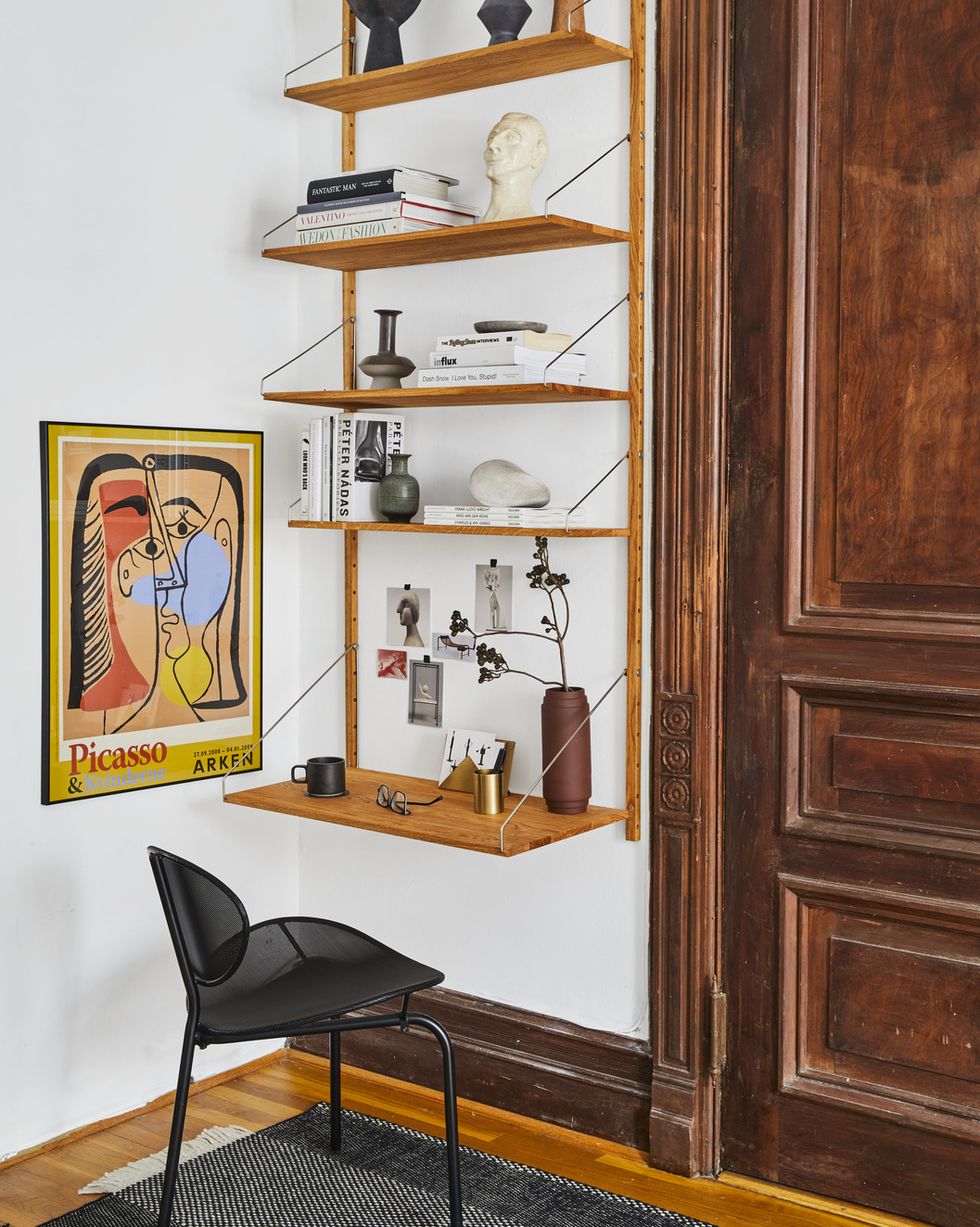 Tariq Dixon, co-founder of furniture brand trnk, writes by installing a shelving unit on an unused wall in an unused corner of his apartment, turning a small space into a writer's oasis.