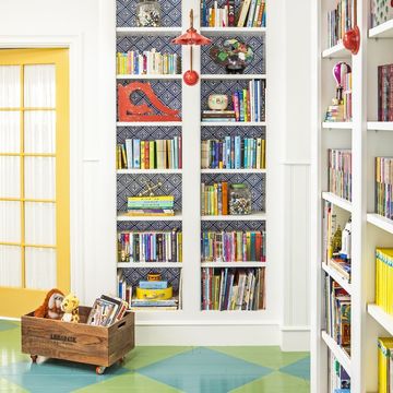 wheeled crate stuffed animal storage idea holding toy giraffe and ape in room with bookshelves