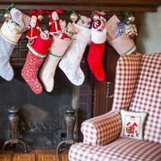 stuffed christmas stockings over fireplace