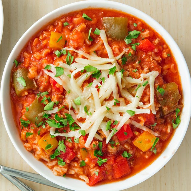 stuffed pepper soup in a bowl topped with shredded cheese