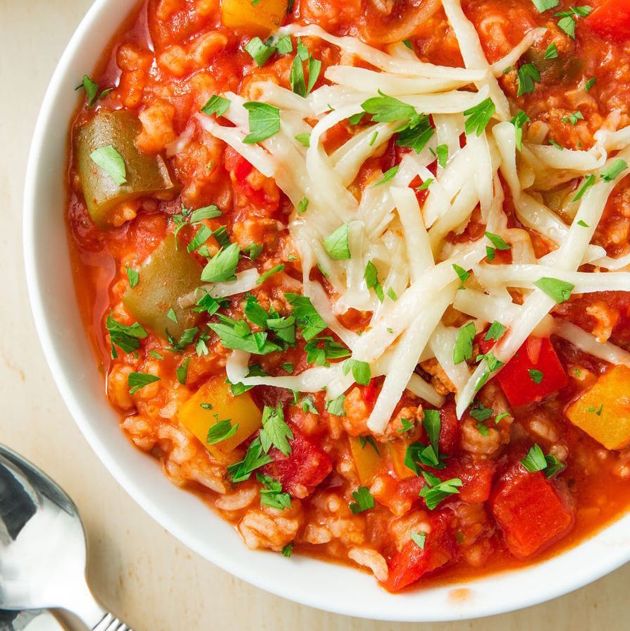 stuffed pepper soup in a bowl topped with shredded cheese