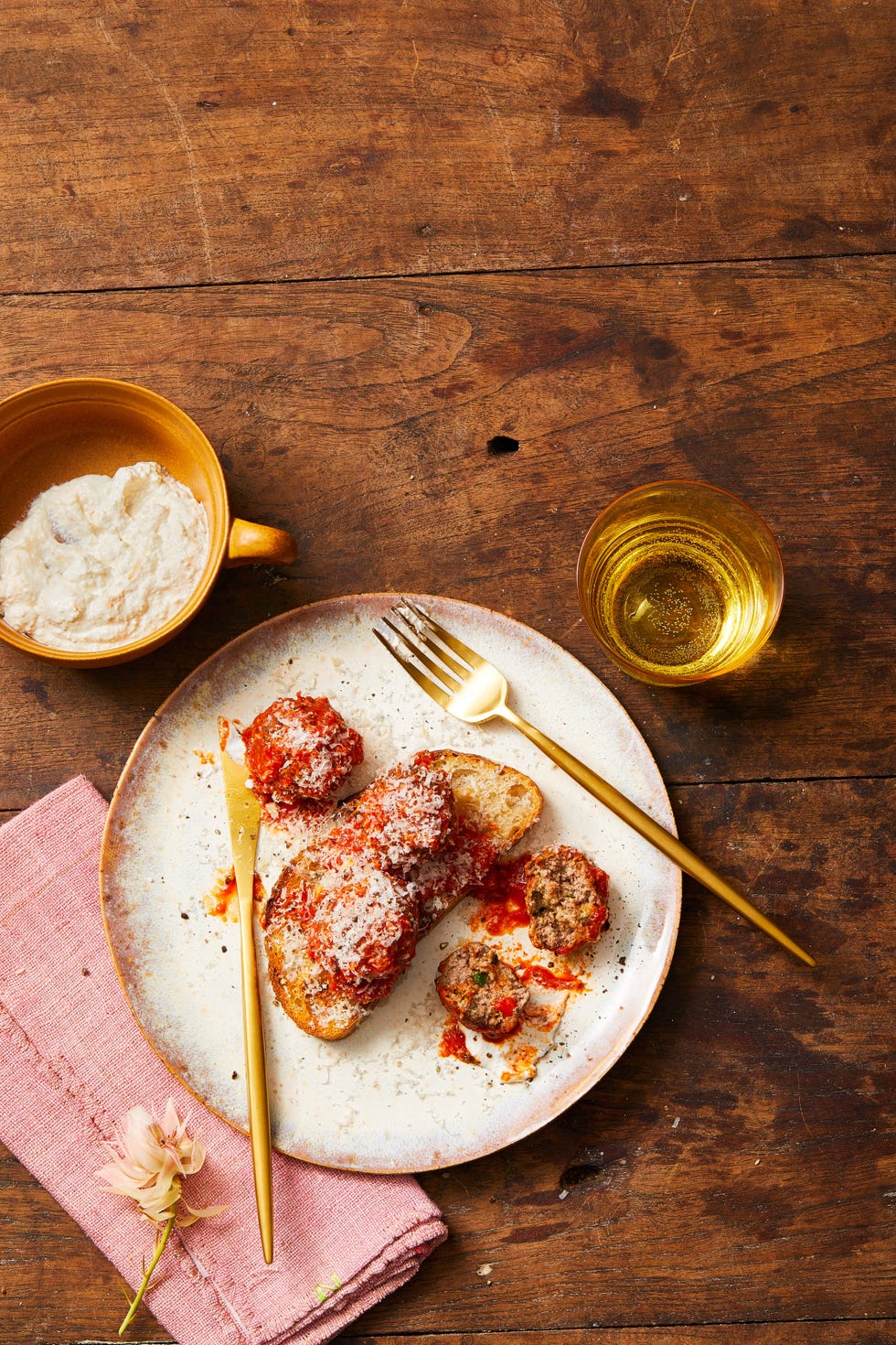 meatballs with red sauce on a piece of bread