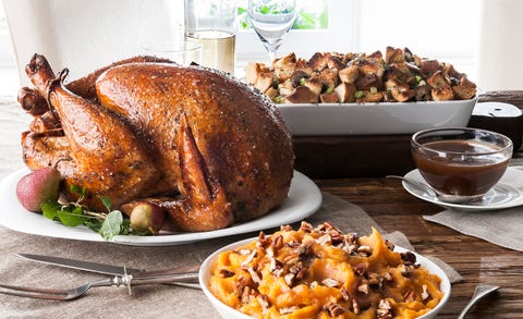 stuffing, sweet potatoes and smoked turkey on wooden table