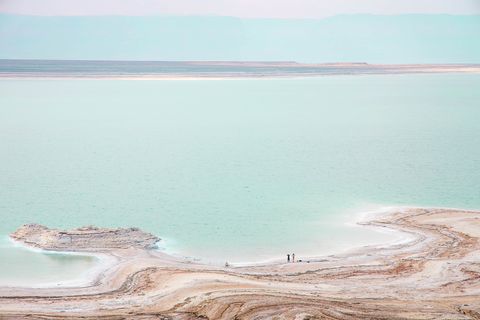 stunning colors of the dead sea with tiny people