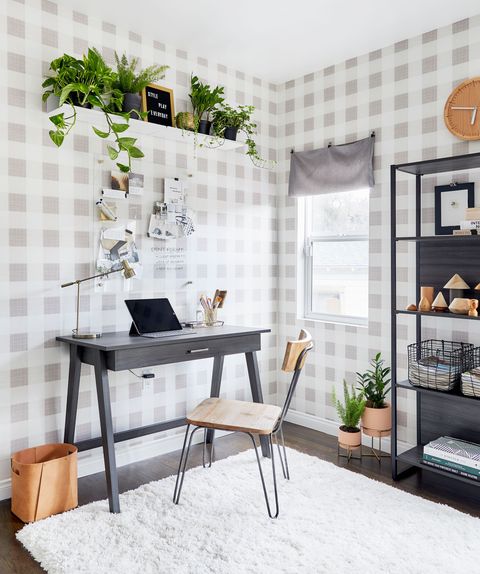 home office with black desk and glass bulletin board