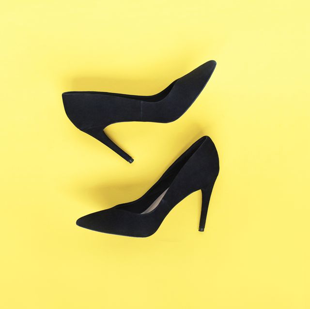 Stylish fashion black shoes high heels on yellow background. Flat lay, top view trendy background. Fashion blog look.
