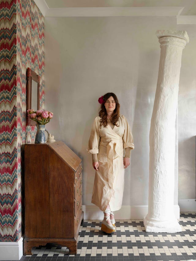 a person standing in a richly decorated hallway