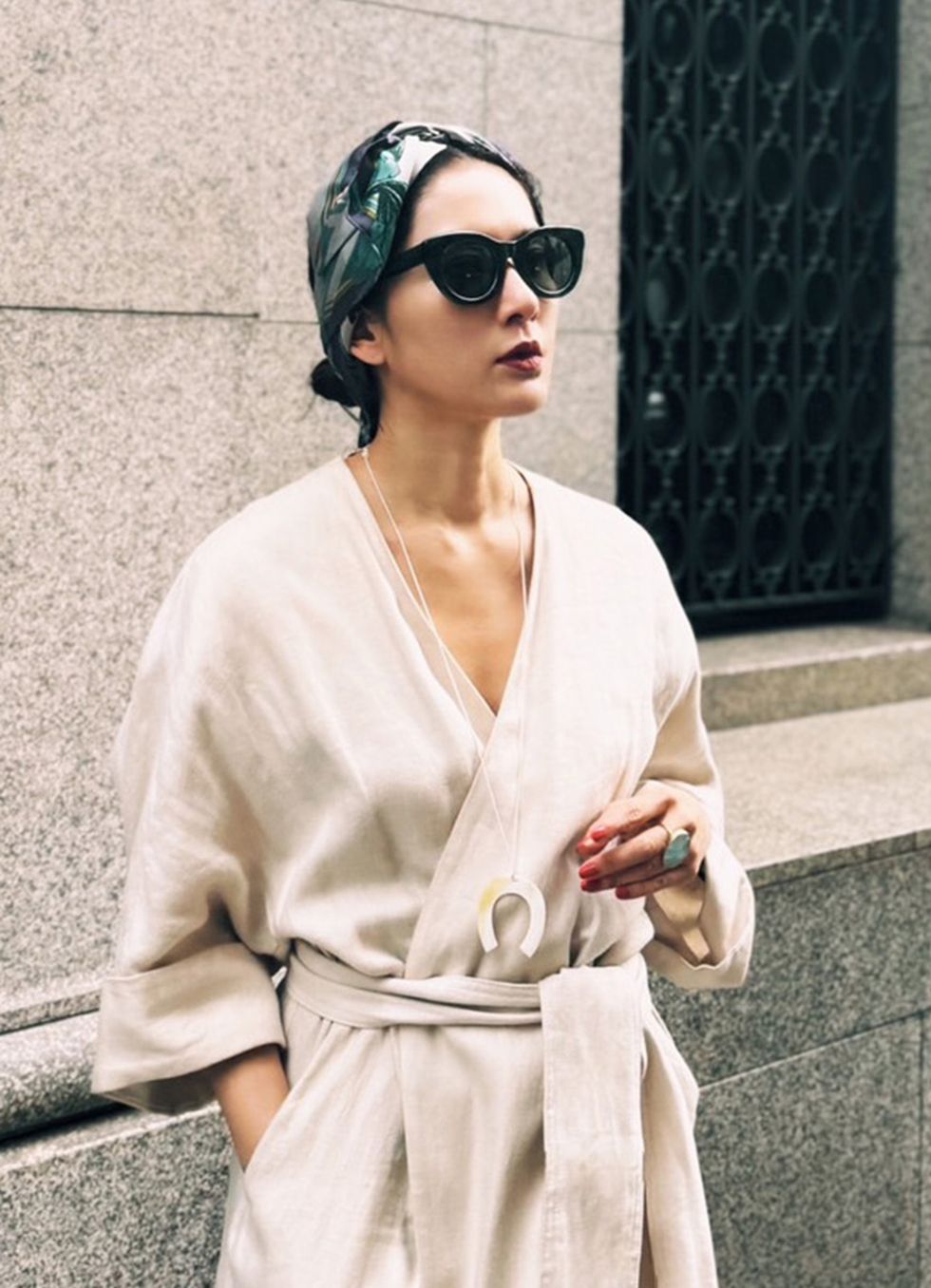 a woman wearing a white dress and sunglasses