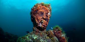 baiae, naples, campania, southern italy may, 2018 submerged statue head