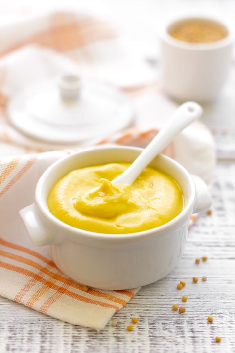 mustard in white jar with spoon