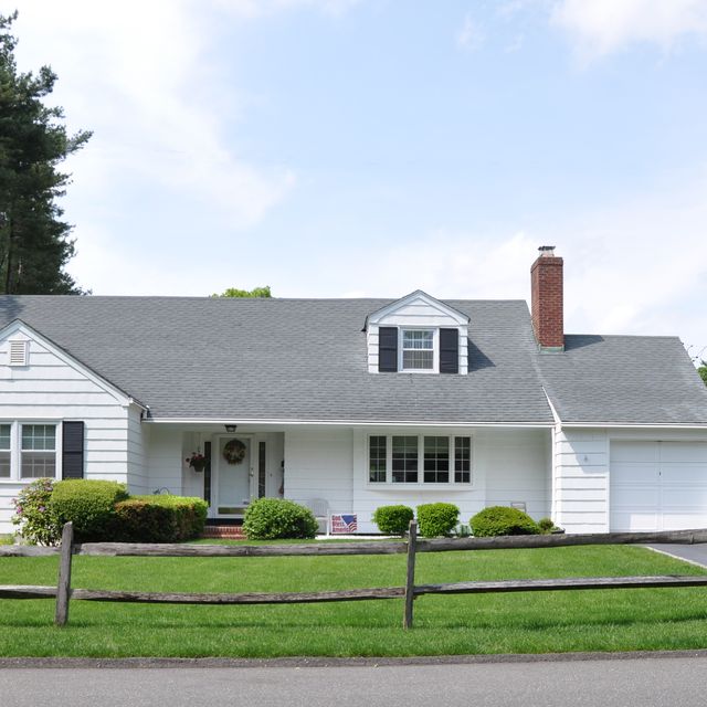 suburban white ranch home wood coral fence