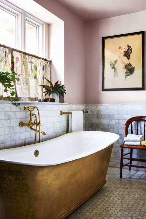 gold bath tub in pink bathroom