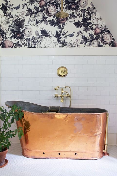 copper bathtub and floral wallpaper