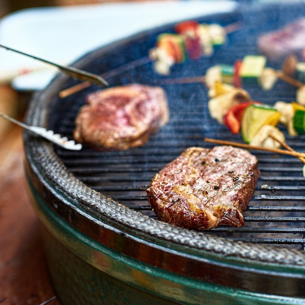 succulent steak cooking on bbq grill with vegetables