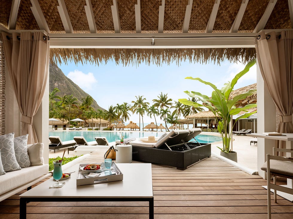 a deck with a pool and chairs