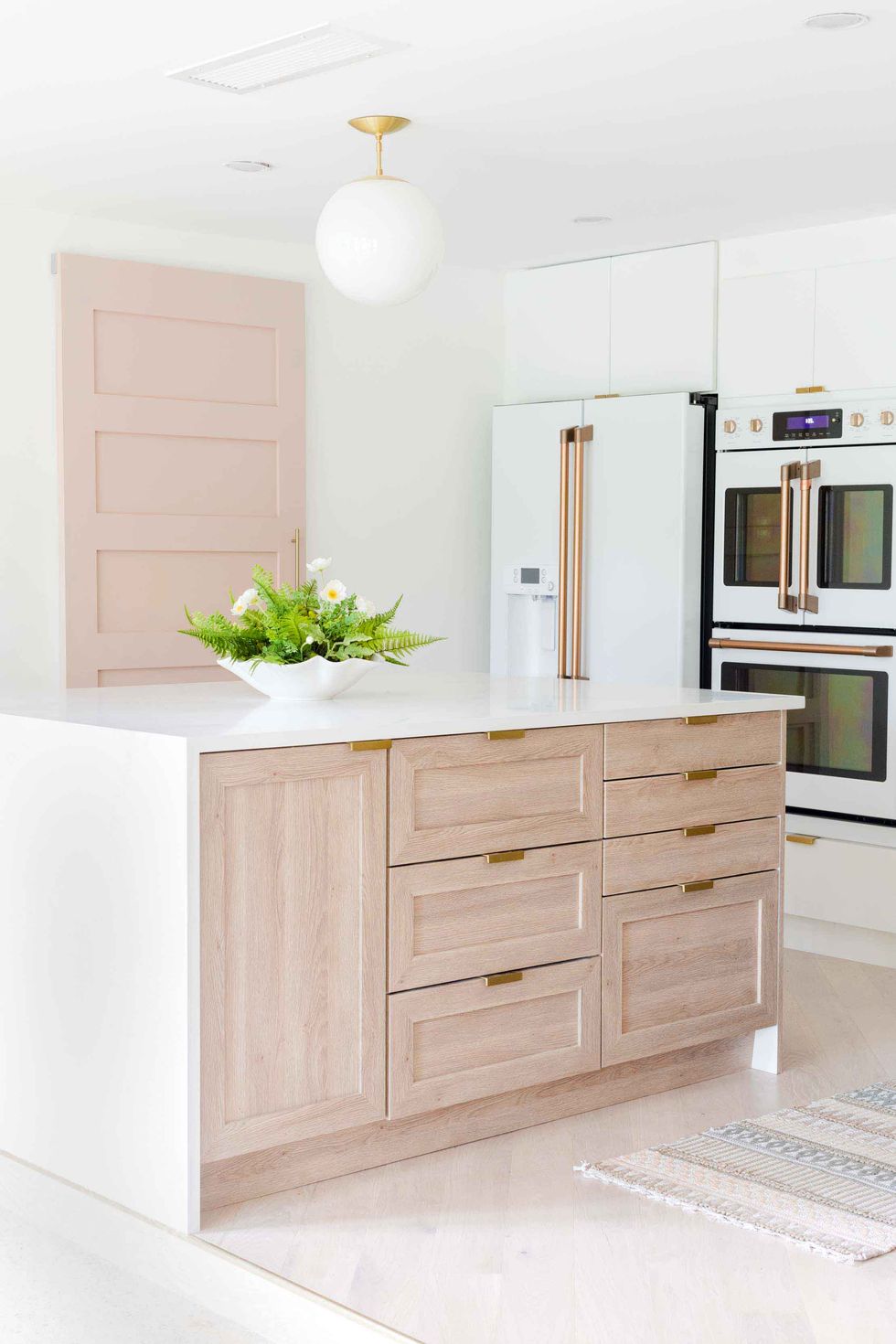 kitchen island idea with light wood drawers and a cabinet door