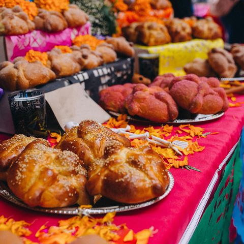 sugar coated pan de muerto at a fair for day of the dead in roma district, mexico city, mexico