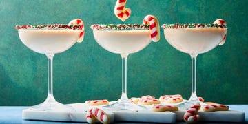creamy martini with sprinkles rim and a candy cane sugar cookie garnish