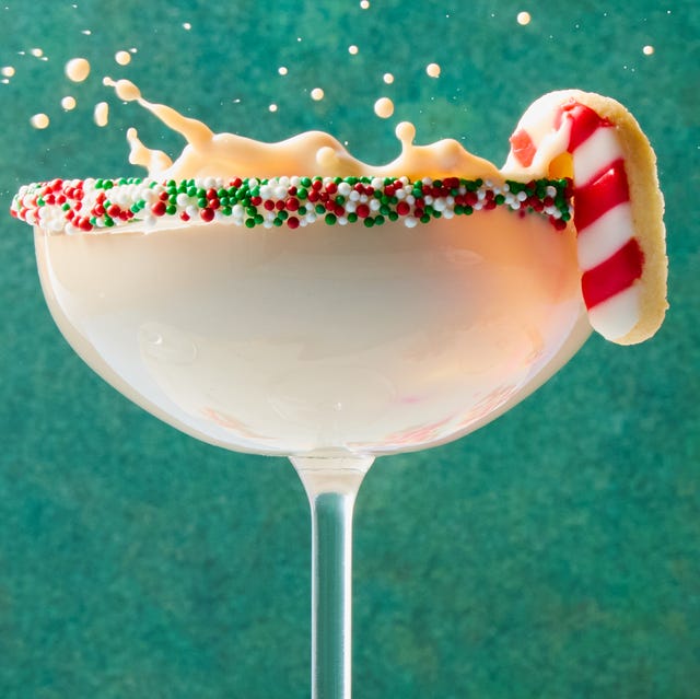 creamy martini with sprinkles rim and a candy cane sugar cookie garnish