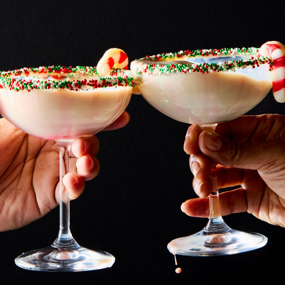 creamy martini with sprinkles rim and a candy cane sugar cookie garnish