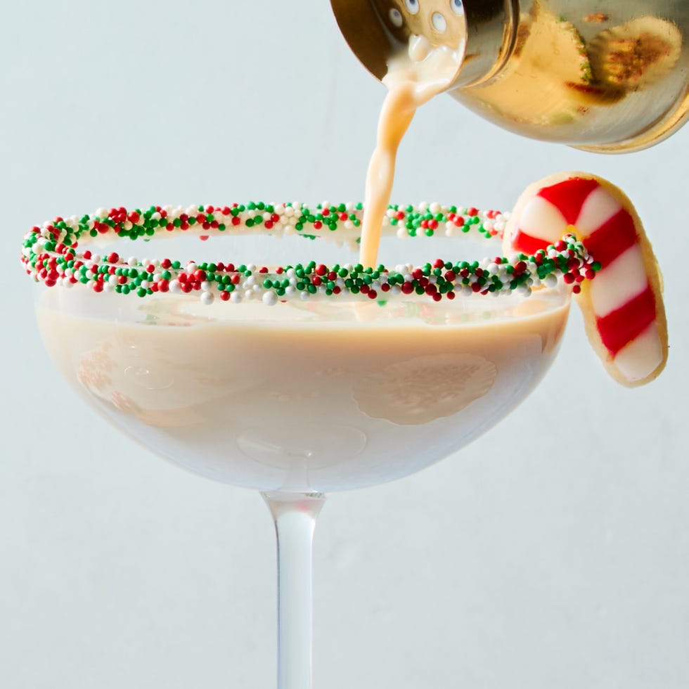 creamy martini with sprinkles rim and a candy cane sugar cookie garnish