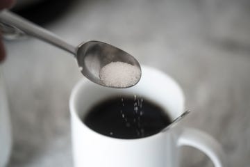 study sugar significantly raises risk of heart disease, stroke, sugar on coffee spoon in front of mug with black coffee