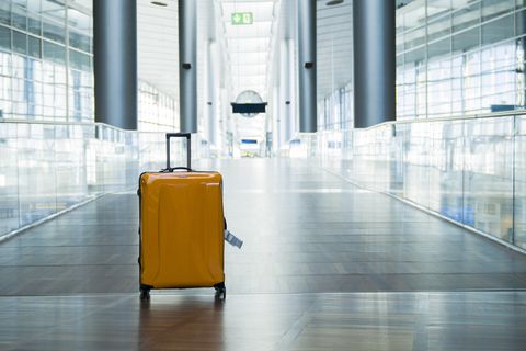 suitcase or baggage with airport luggage trolley in the international airport