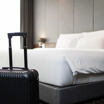 A suitcase placing in front of the bedroom in luxury hotel room a suitcase placing in front of the bedroom in luxury hotel room