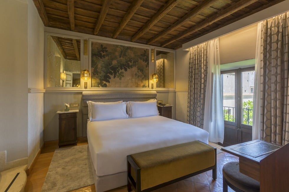 hotel room featuring a bed decorative elements and large windows