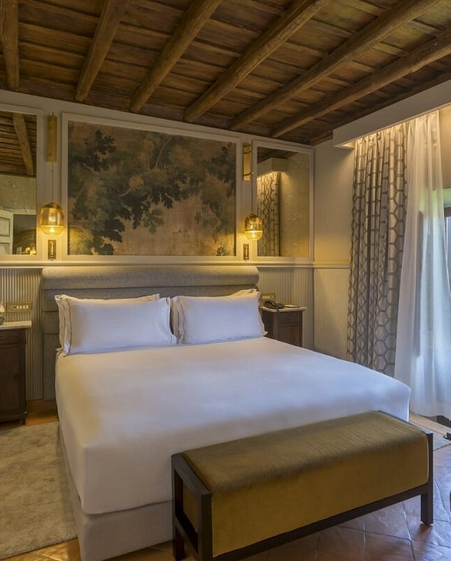 hotel room featuring a bed decorative elements and large windows hotel room featuring a bed decorative elements and large windows