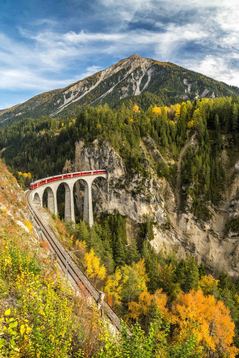 elevated view of bernina express train on landwasser viaduct in autumn, filisur, canton of graubunden, switzerland