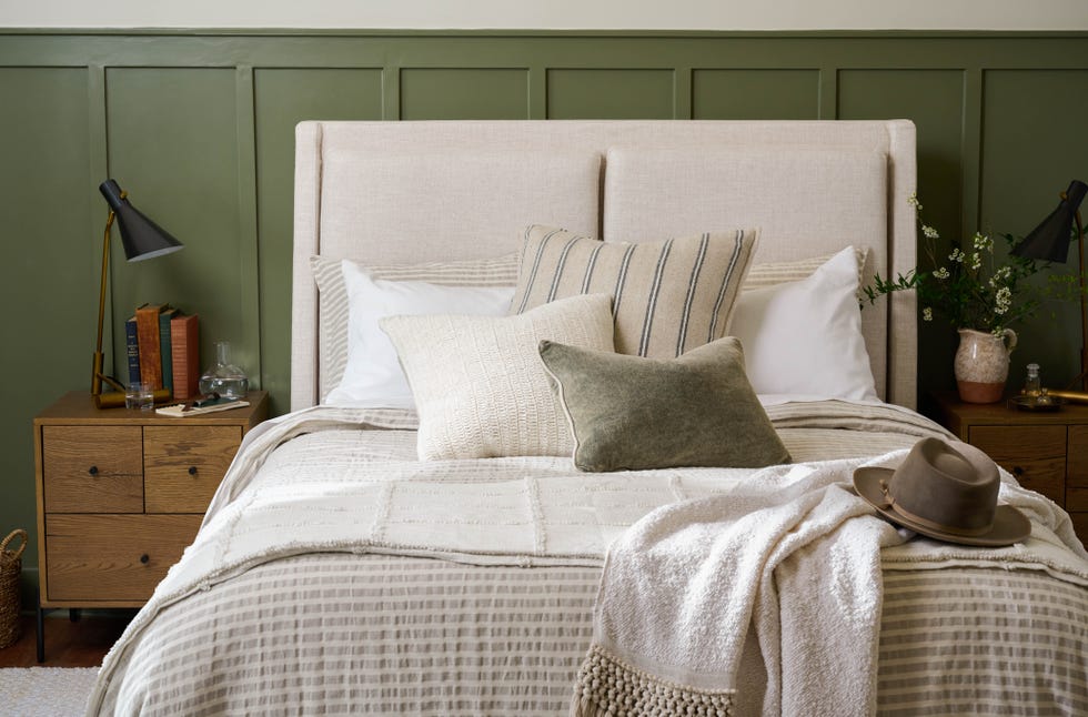 bedroom with green wall and faux plants