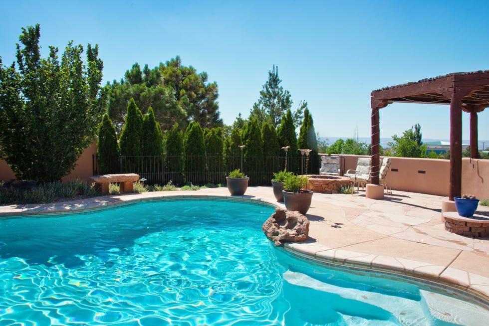 summer back yard patio with swimming pool