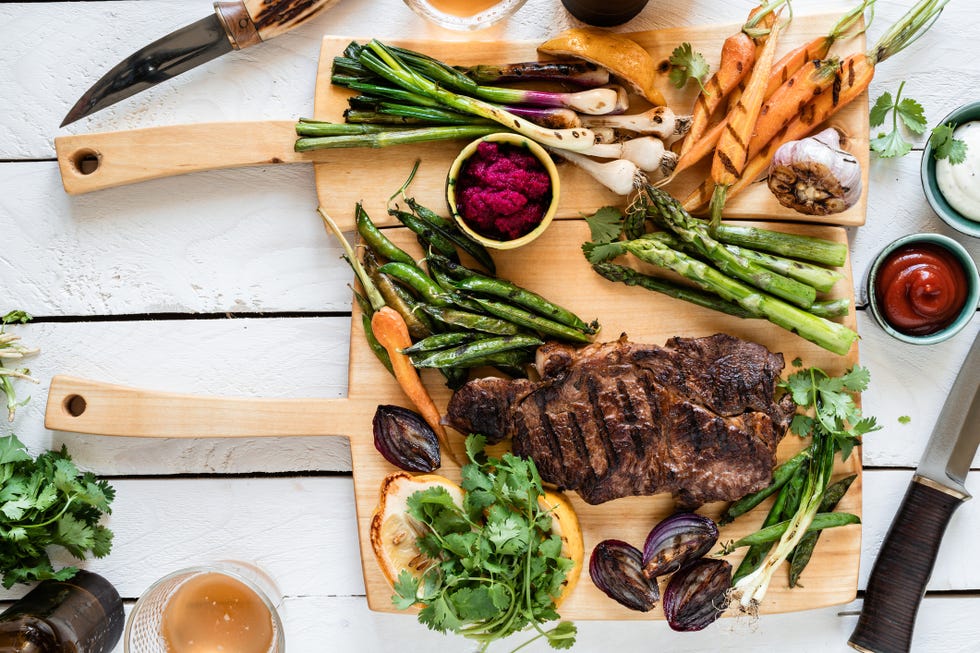 summer bbq meal organic roasted beef meat and vegetables, picnic table top view