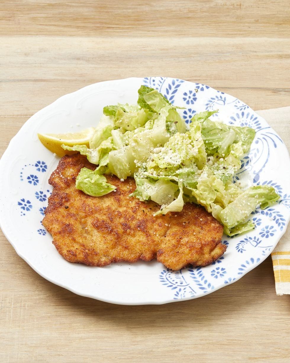 chicken caesar milanese on plate with lemon
