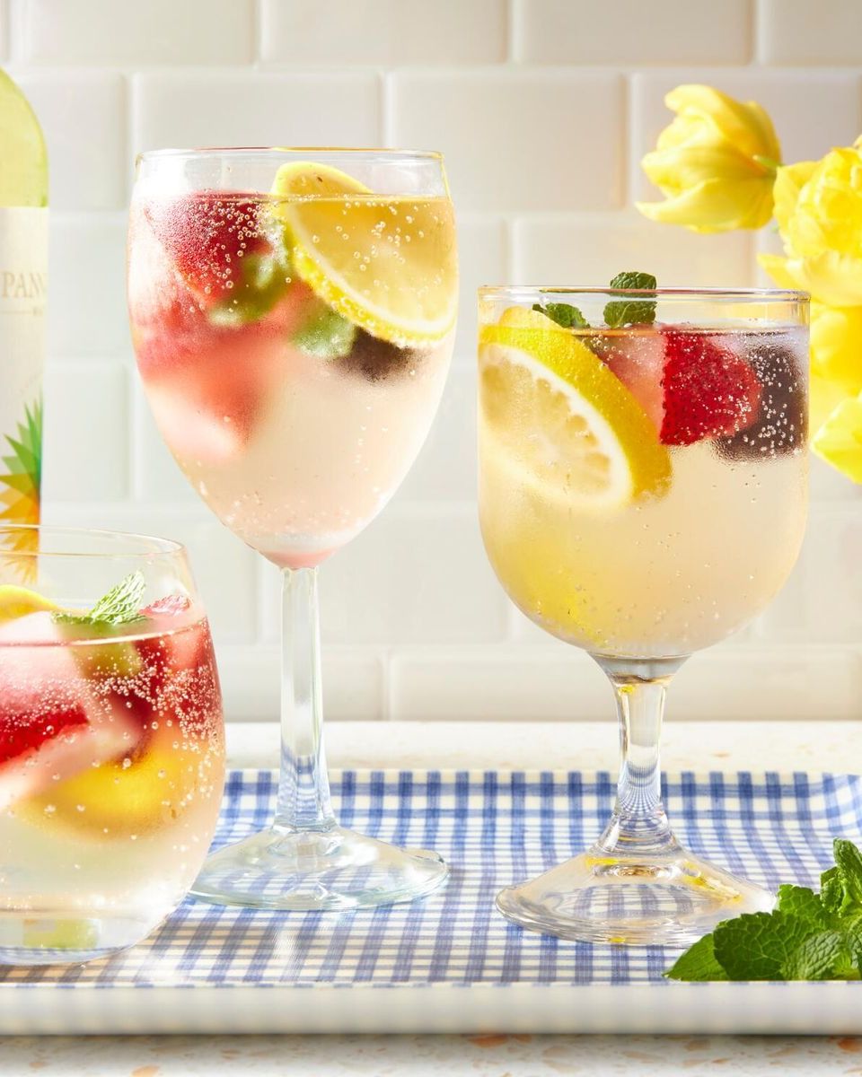 Collection of different summer party drinks in batch glasses