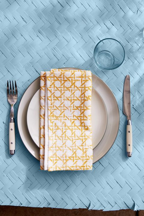 white napkin hand stamped with a bright yellow cane pattern for summer
