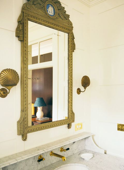 bathroom with bronze shell sconces