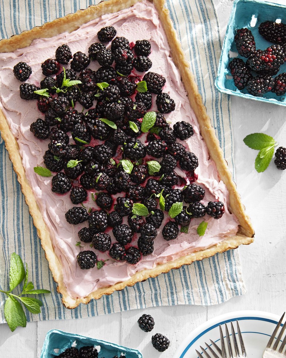 blackberry tart topped with blackberries and mint leaves for garnish