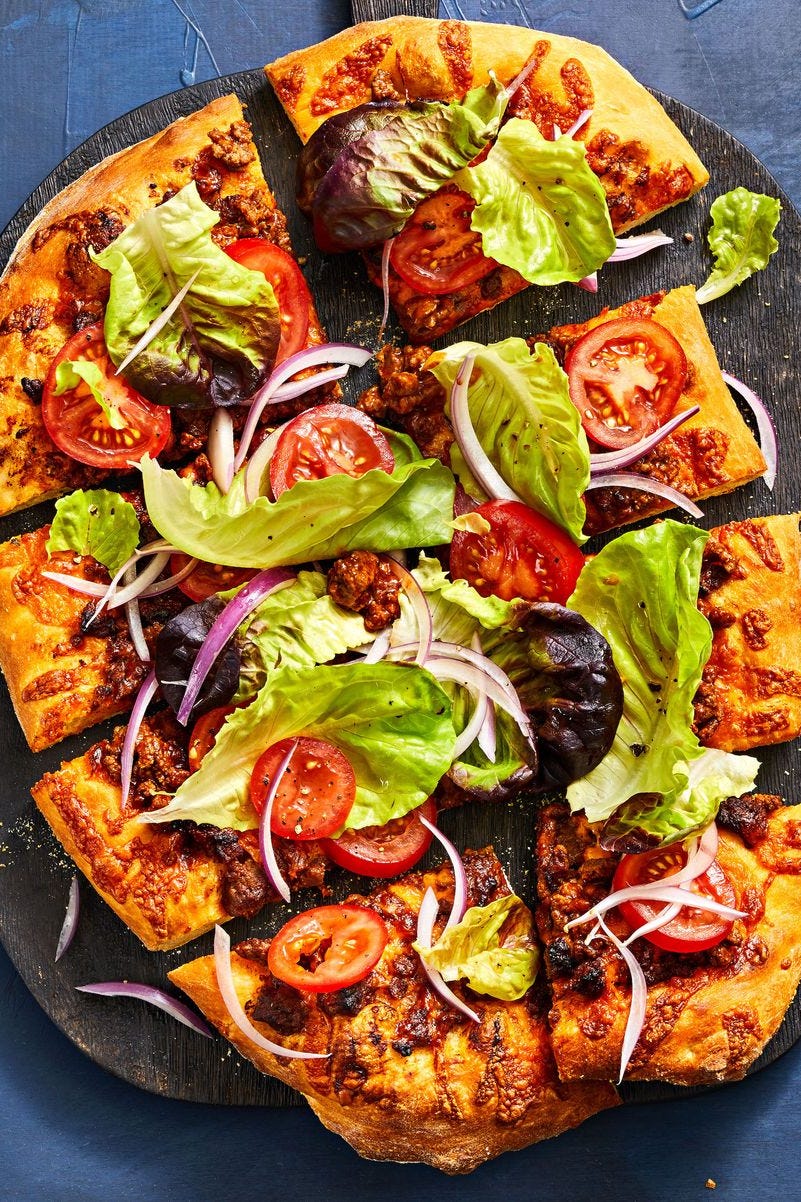 cheeseburger style pizza with tomato and lettuce