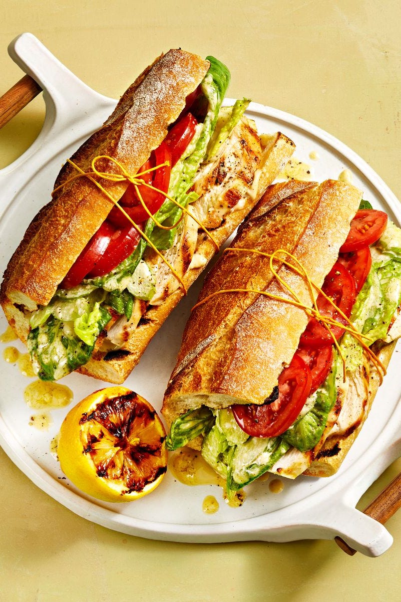 chicken sandwich with tomato and lettuce on a baguette