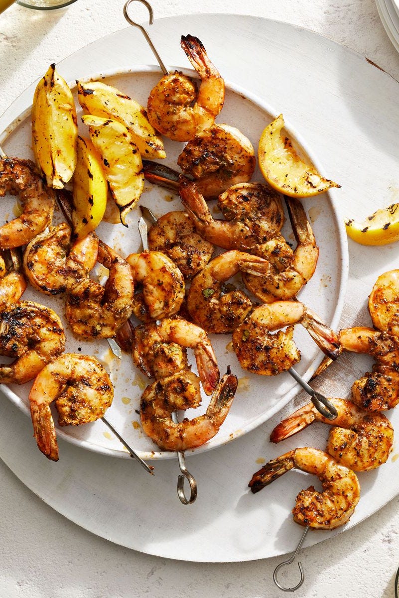 grilled shrimp on skewers on a white plate