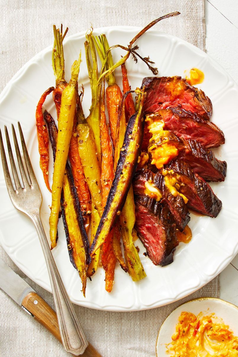 harissa butter steak with carrots on a white plate
